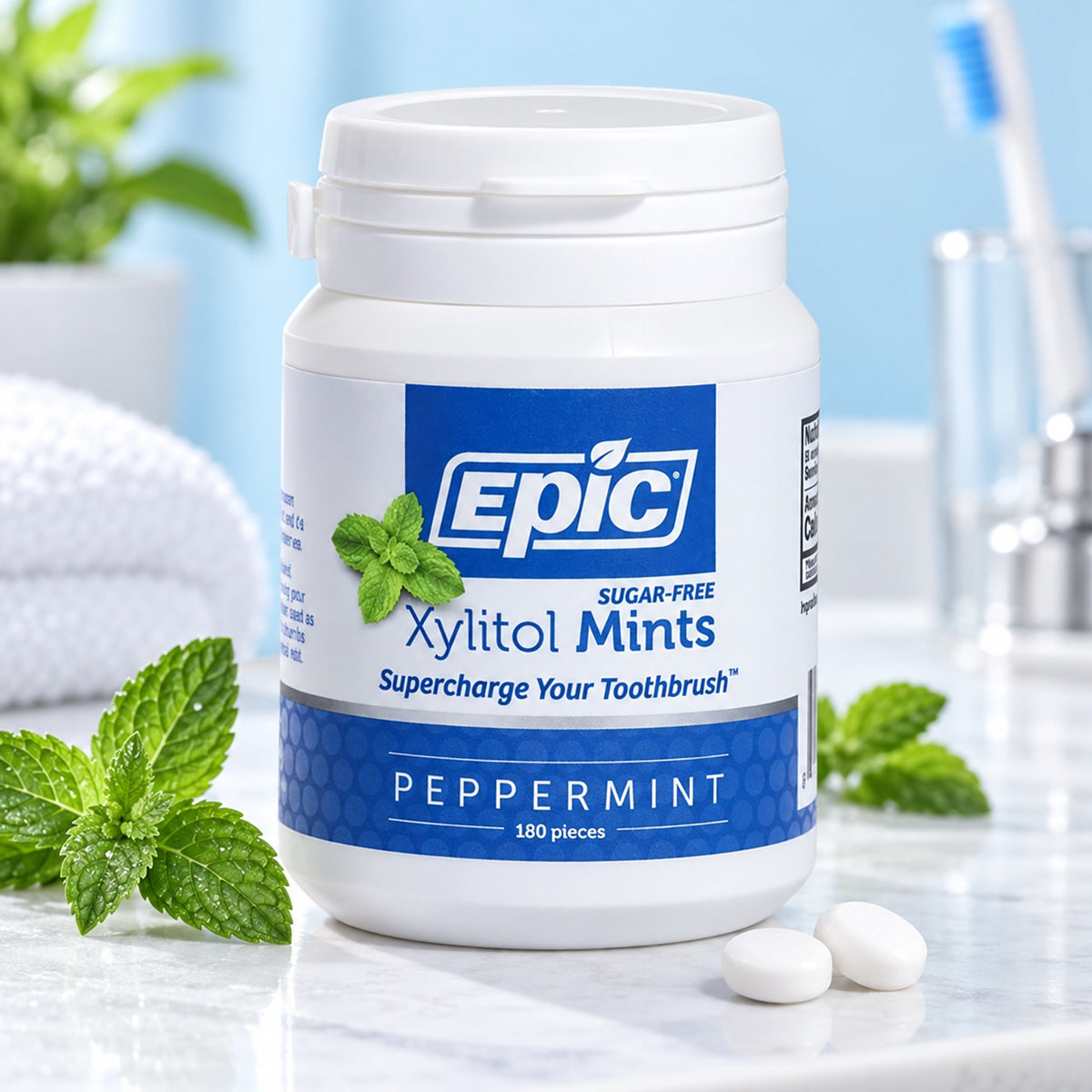 EPIC xylitol peppermint dental mints with fresh peppermint leaves in an oral care setting
