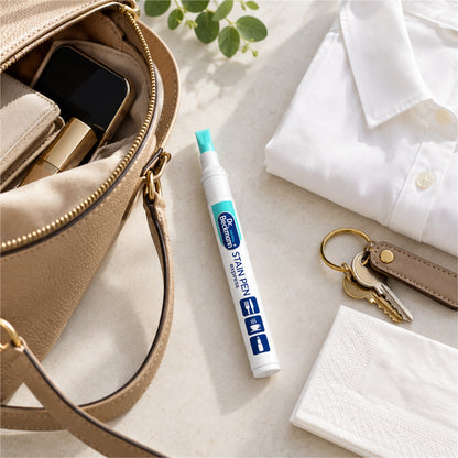 Illustrative travel flat lay with a portable Dr. Beckmann Stain Pen Express beside a handbag