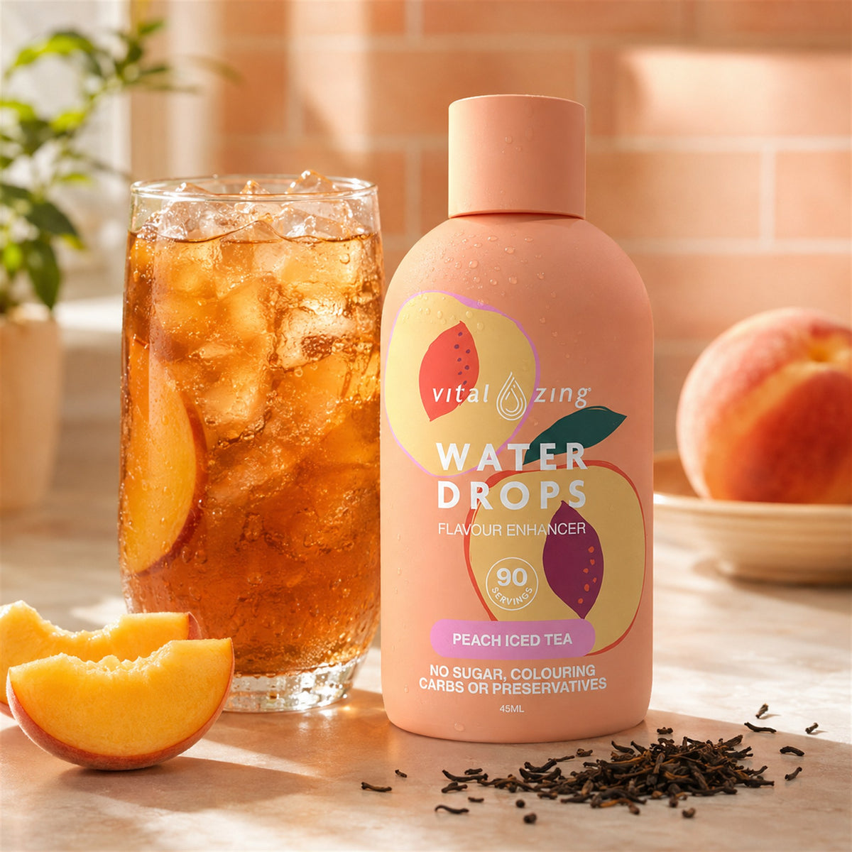Vital Zing Peach Iced Tea Water Drops 45ml beside a glass of peach iced tea